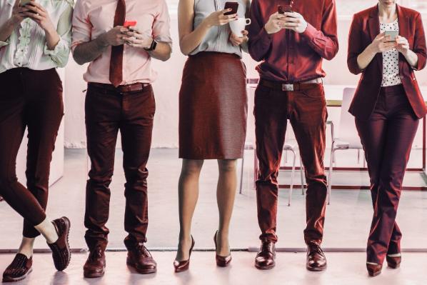 Group of individuals typing on phones