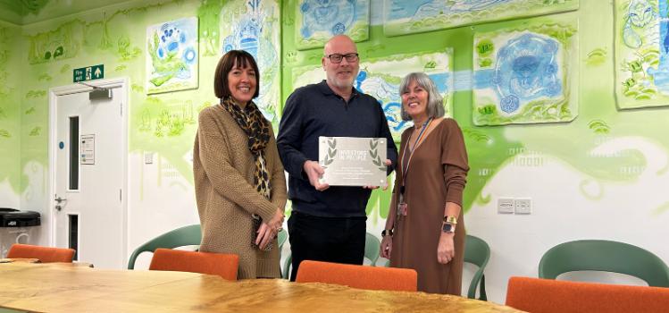 Professor Karen Rafferty, Allister Lee and Gillian Purdy stand with the Investors in People Silver Award for 2024