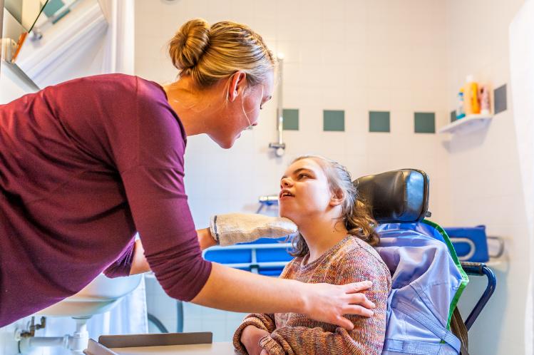 Nurse caring for young person with disabilities