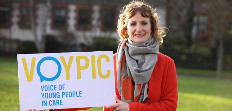 Alicia Toal holding a VOYPIC banner