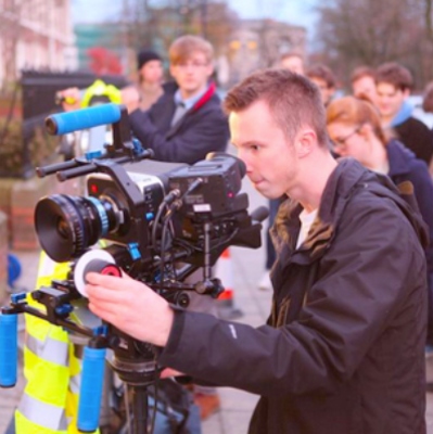 A group of students filming on location