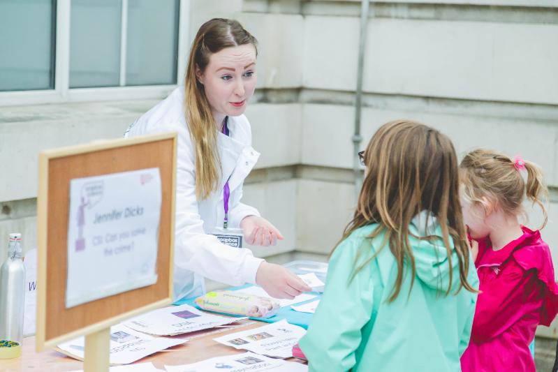 A scientist talking to a child