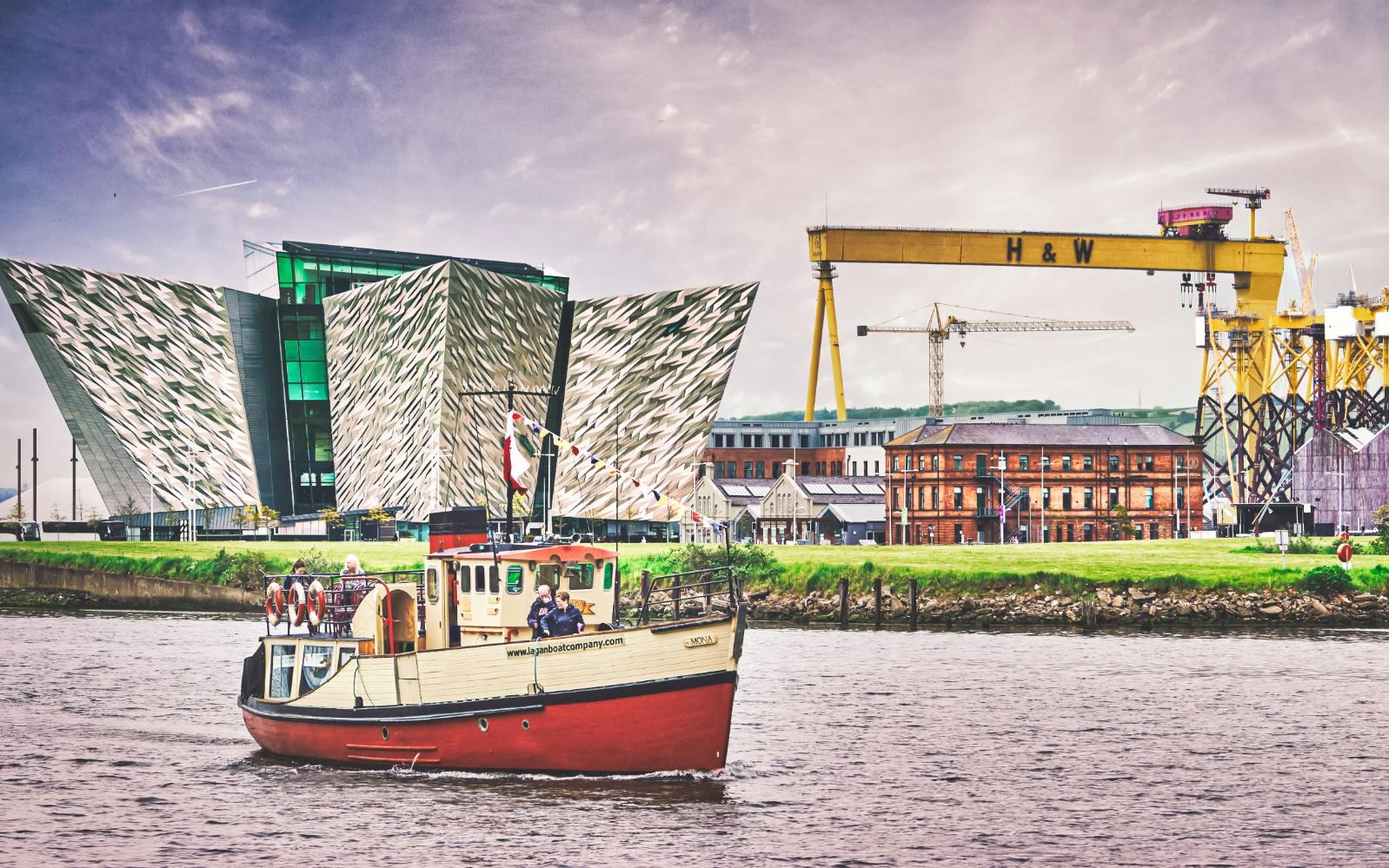 A boat floats past the Titanic Centre with the H&W crane in the background