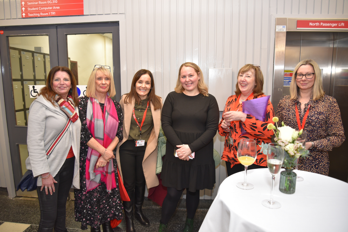 Six attendees at the Florence Nightingale Exhibition smiling