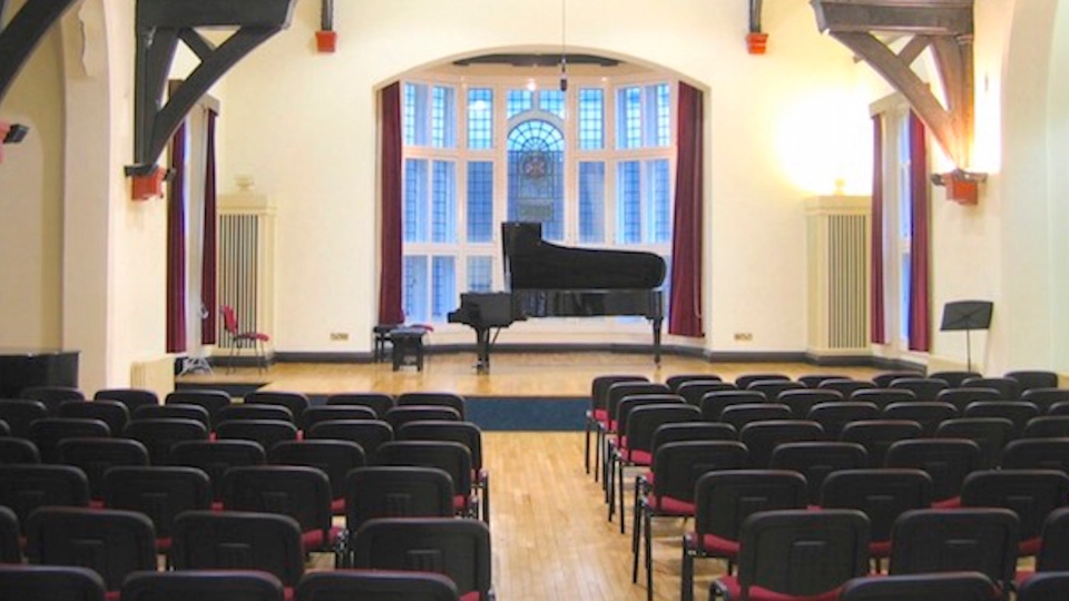 Piano on stage with seating at the front