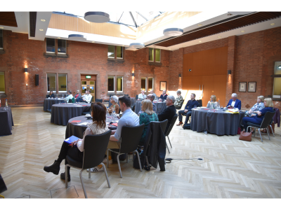 Passion HF Consortium Delegates listening to the presenter as sun streams through the glass ceiling