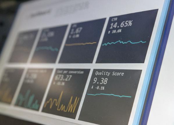 A laptop screen reporting various data panels