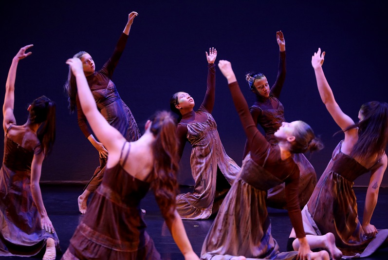 Several female members of the Limerick Youth Dance Company ensemble taking part in a synchronised perfomance.