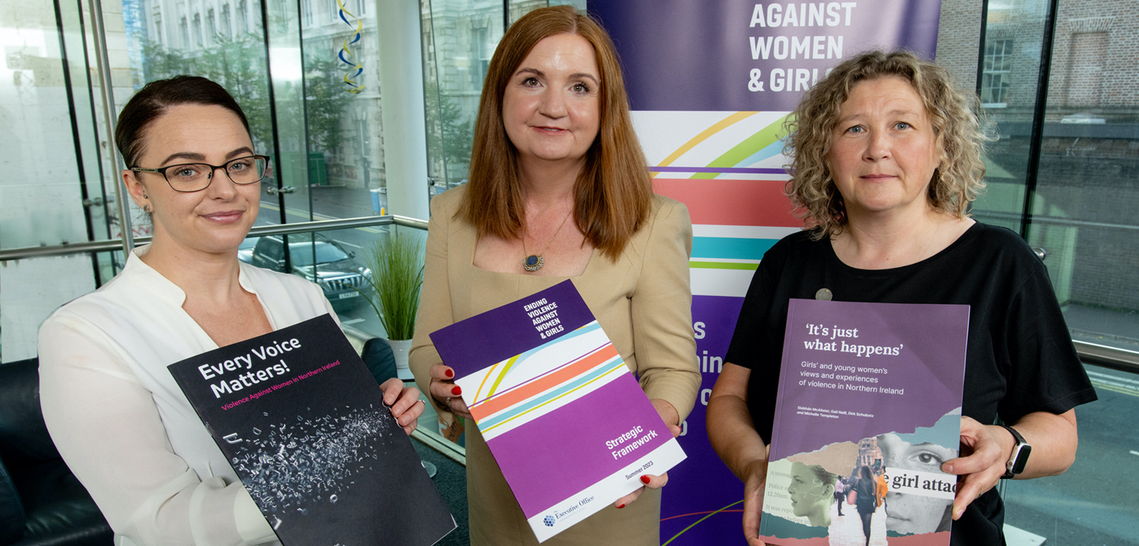 Siobhan McAlister and two women holding reports