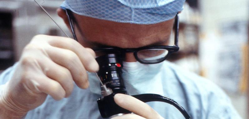 Man in surgery room holding camera