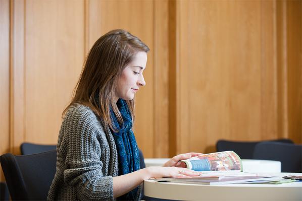 female student reading textbook