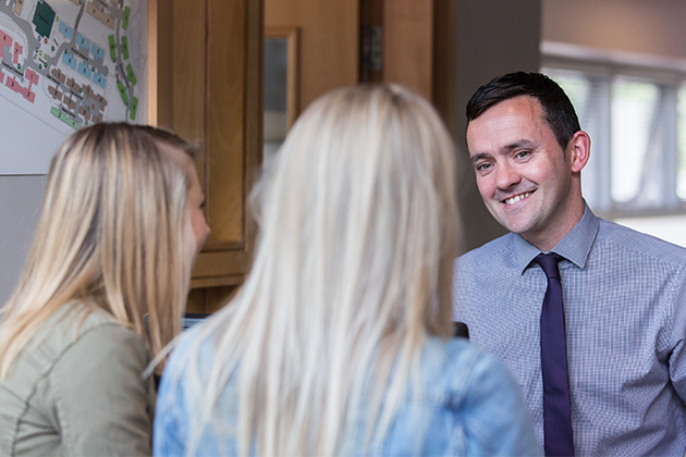 two female students talking to a member of staff in Elms student accommodation office