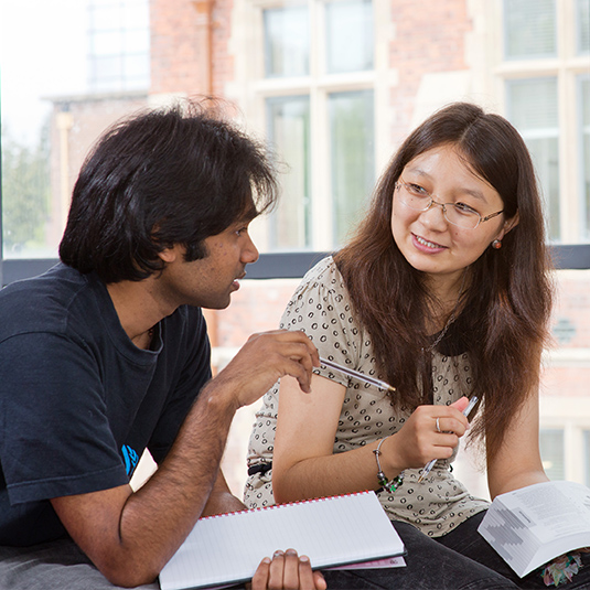 two international students discussing their lecture notes