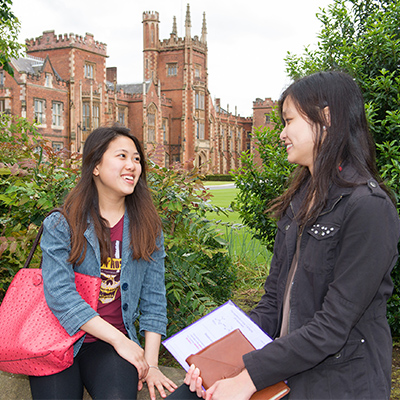 2 female students w lanyon in background