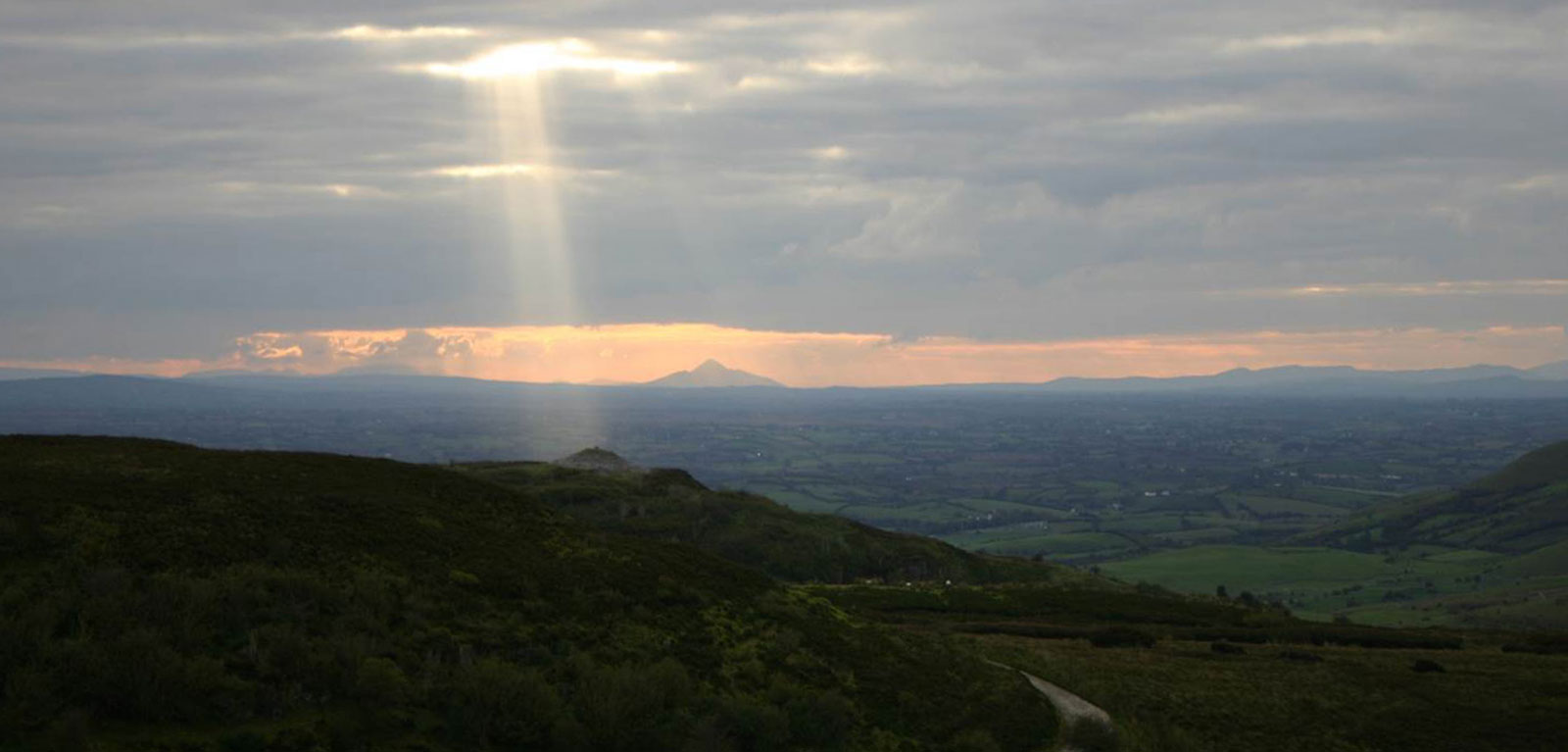 QUB-GAP-Banner-Sunbeam-on-Carrowkeel-passage-tomb-Croagh-Patrick-in-distance