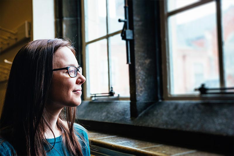 female student looking out of a window