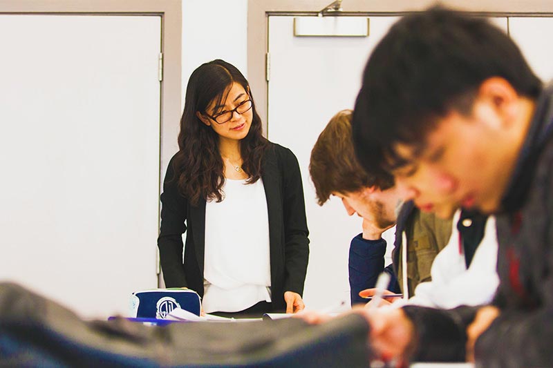 Students taking notes in a classroom