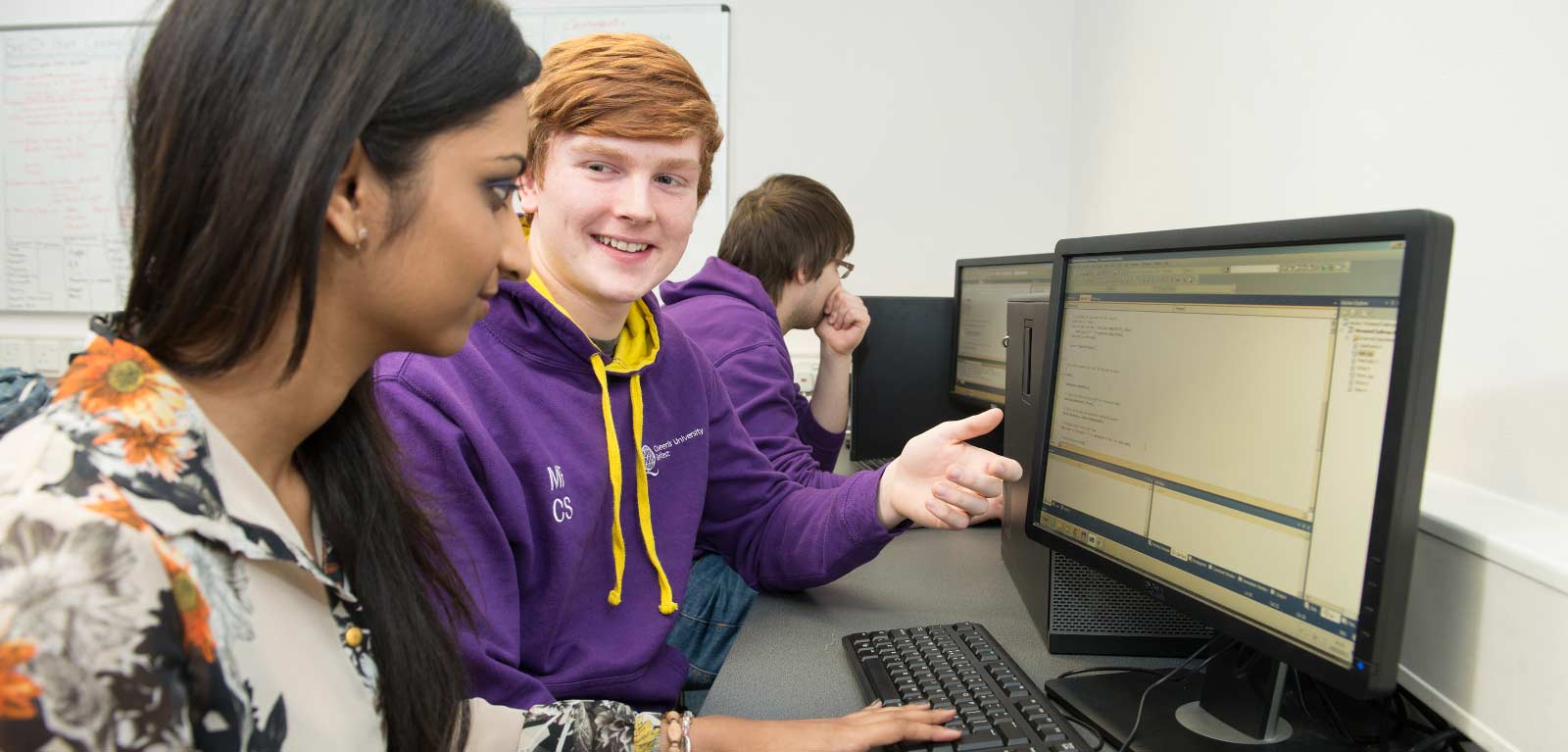 School student ambassador assisting a computer user