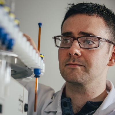 male student looking at samples in a lab