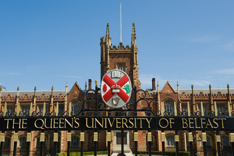 Queen's crest on main gate with Lanyon building in the background