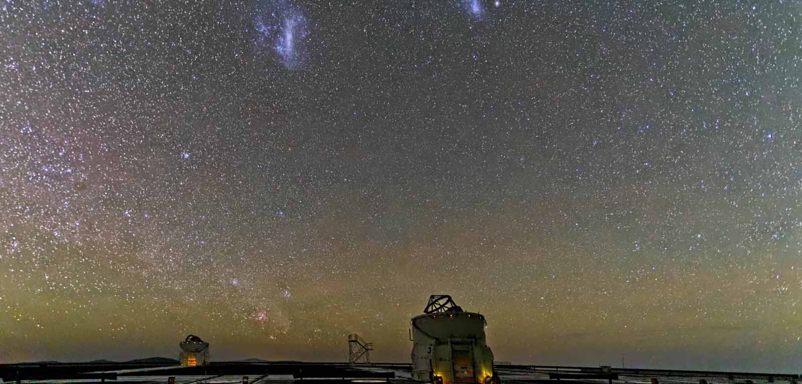 Expanse of stars seen from earth with telescope at bottom