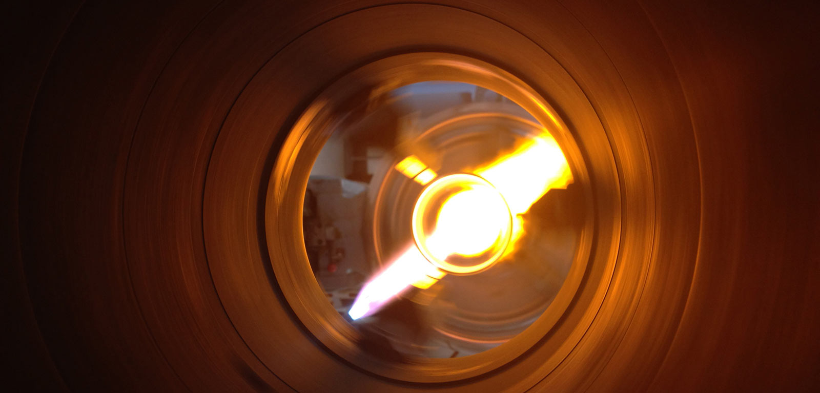 Glass blower forming a chemistry glass, closeup view, glass blower