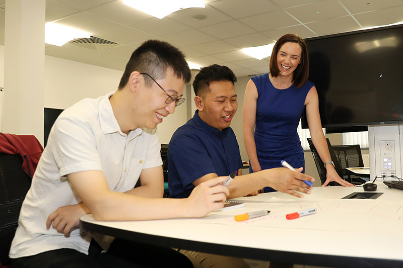 Students at Riddel Hall with a tutor