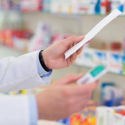 An image of a pharmacist holding a prescription.