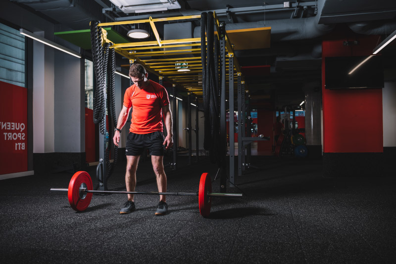 Person lifting weights in gym