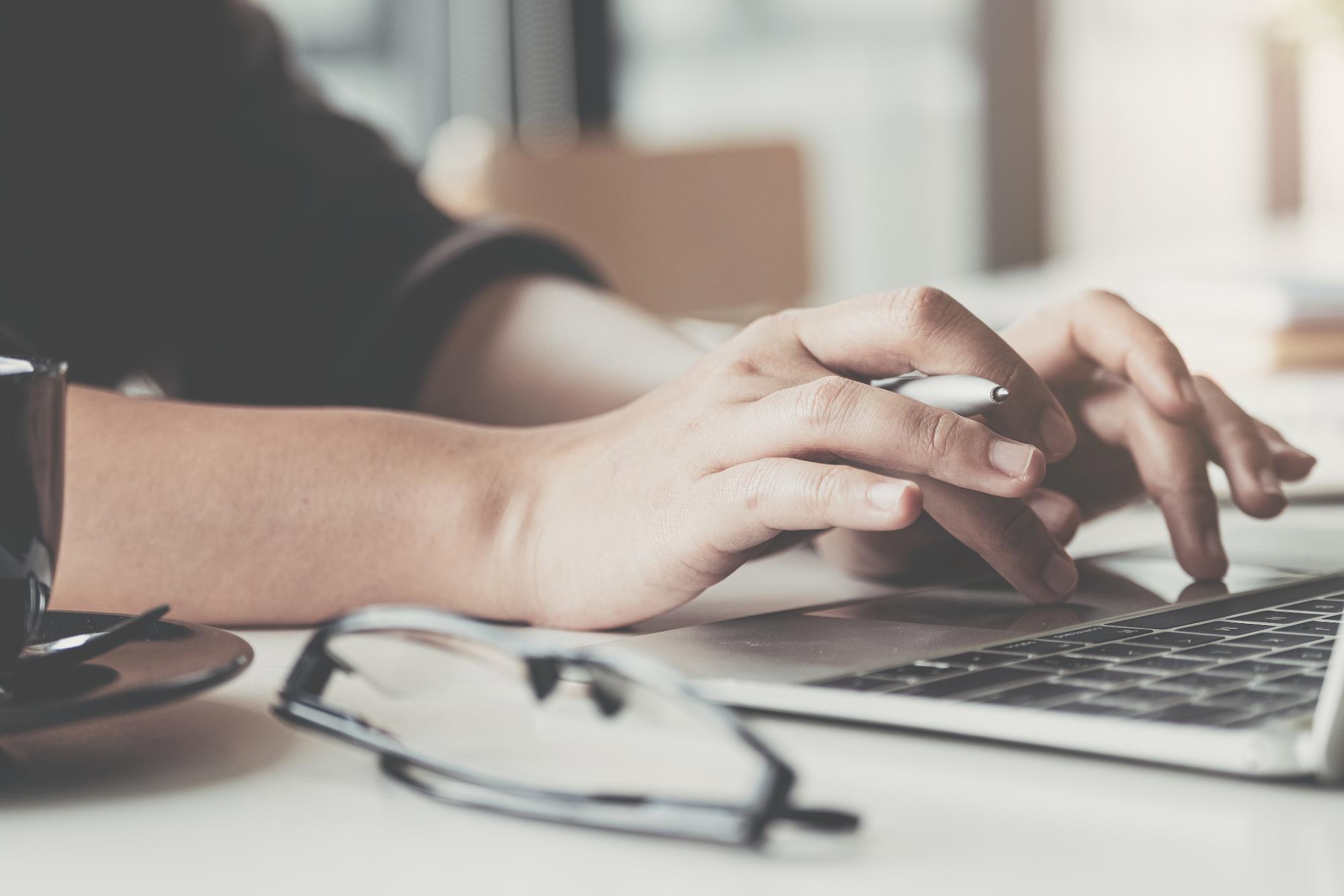 An image of someone typing on a computer