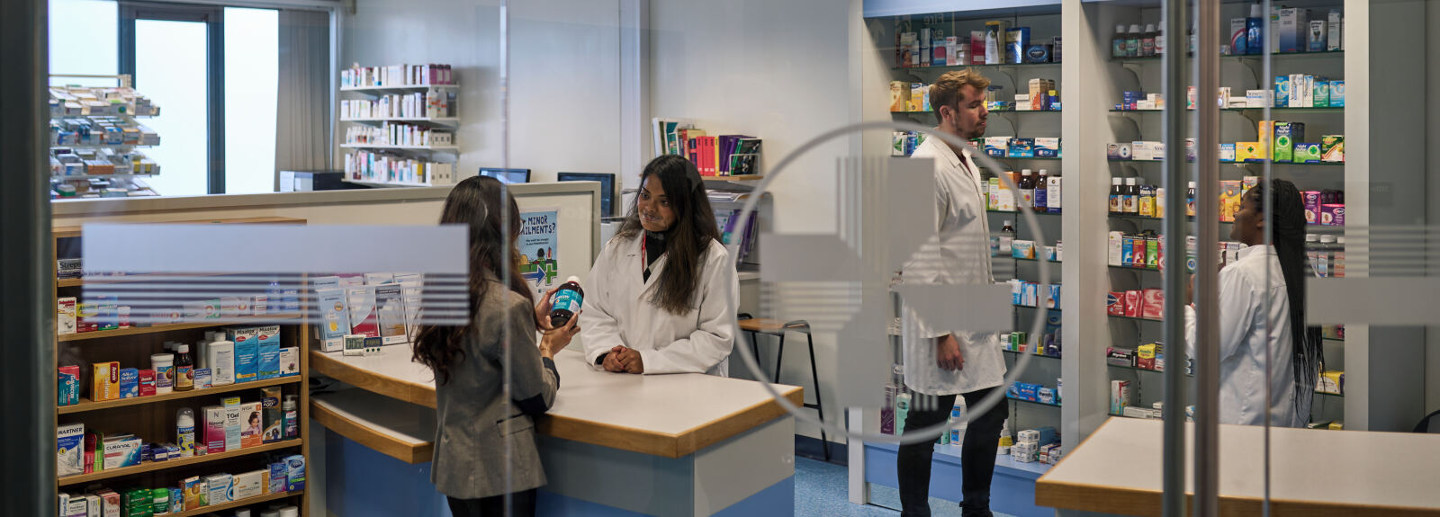Students studying in a pharmacy shop