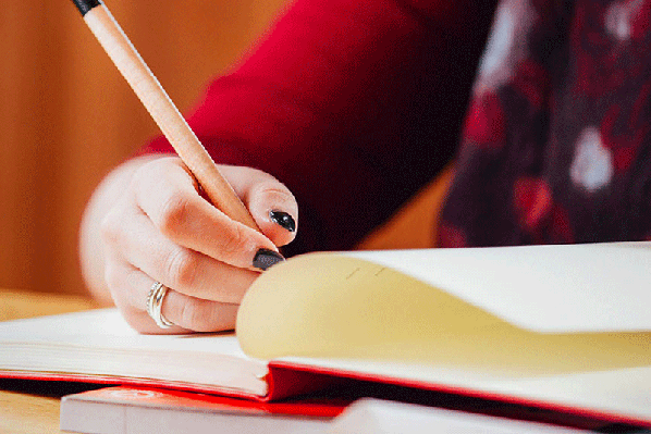 A person writing in a notebook