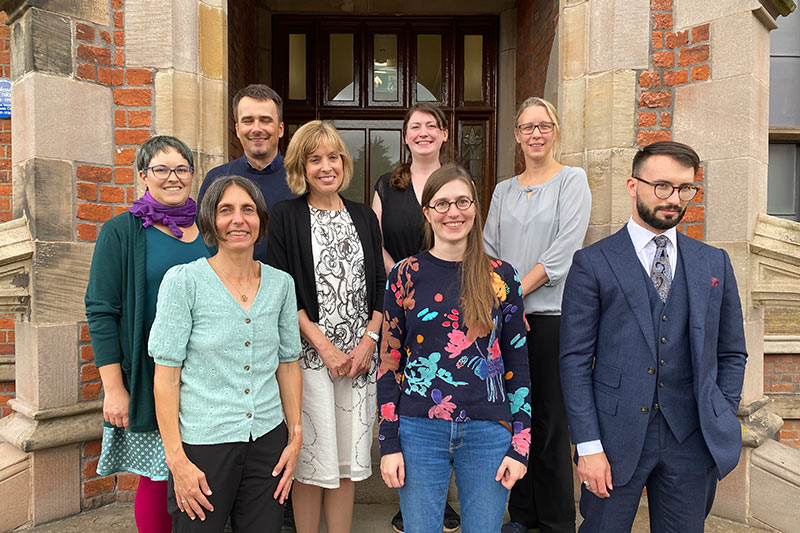 group of people standing in front of a doorway