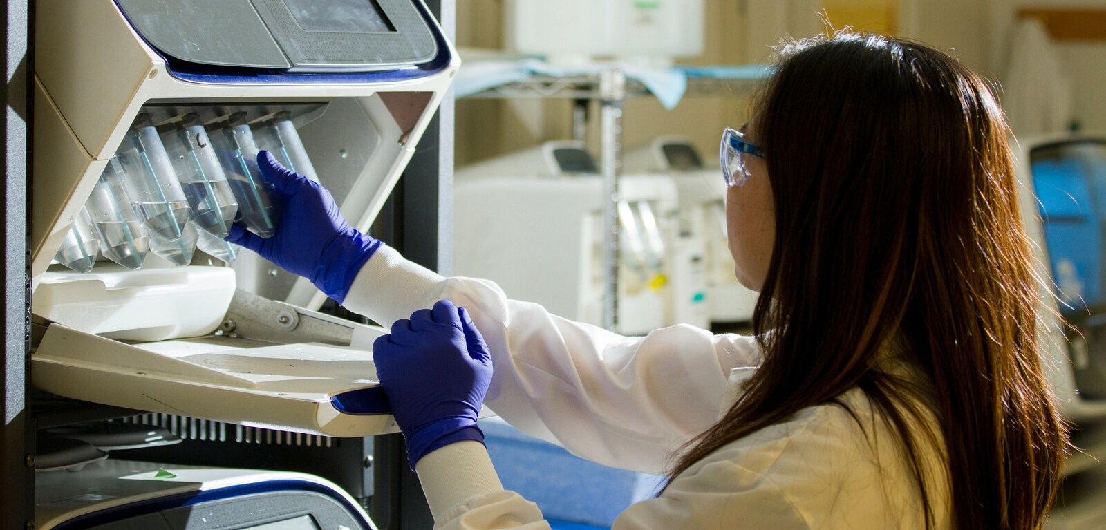 Woman holding test tubes in lab