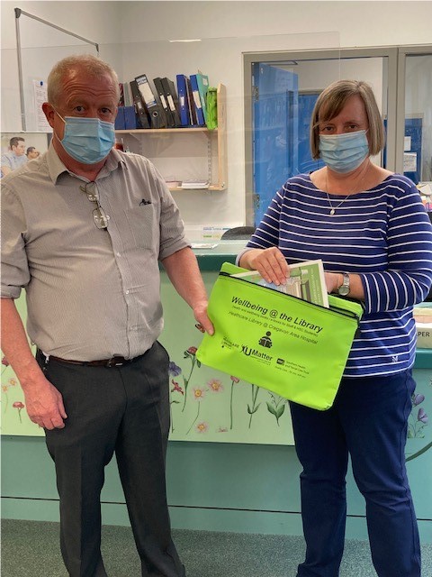 Masked people with wellbeing pack