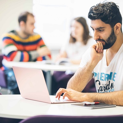 Library user with laptop