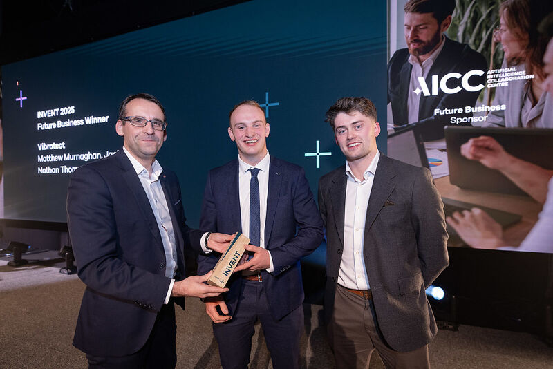 Two men are presented with an award
