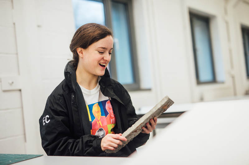 Image of student discussing a piece of concrete