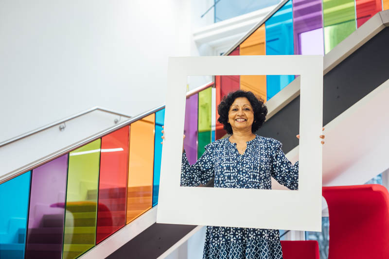 Image of staff member in Computer Science Building with large polaroid frame