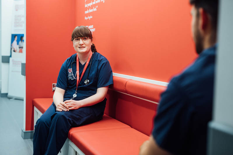 Image of student chatting to another student in InterSim Centre