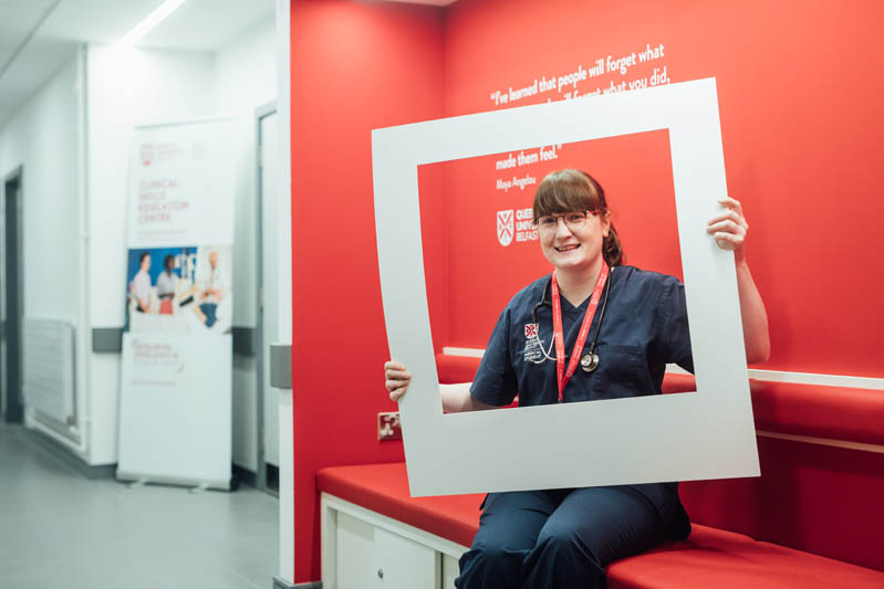 Image of student in InterSim Centre with large polaroid frame