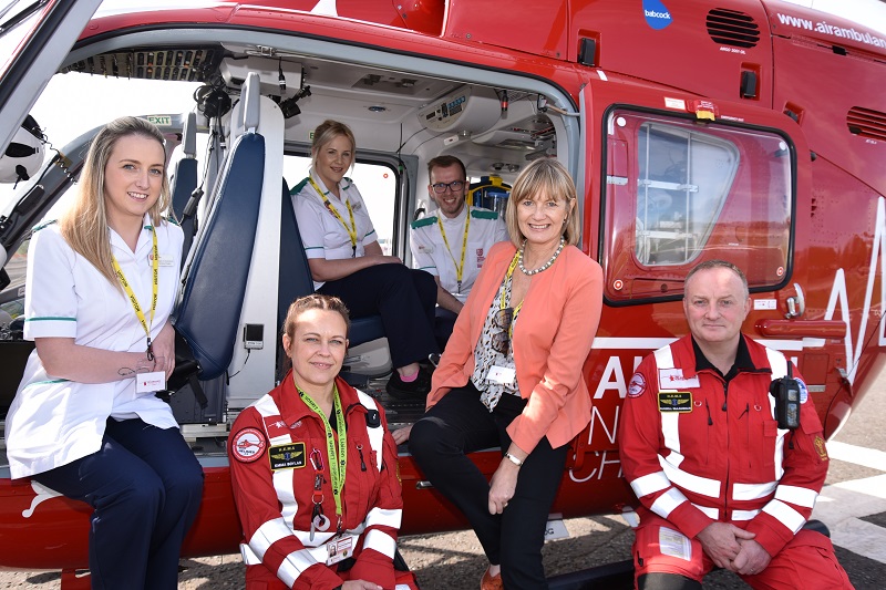 Donna Fitzsimons sitting with nurses and air ambulance crew in a helicopter