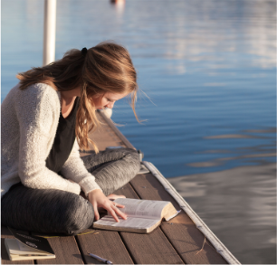 Woman reading a book in a lake
