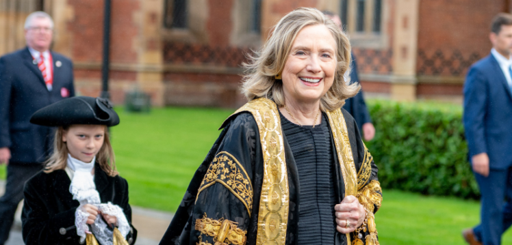 Photograph of the University's Chancellor, Secretary Clinton, in robes walking as part of the procession during her installation as Chancellor