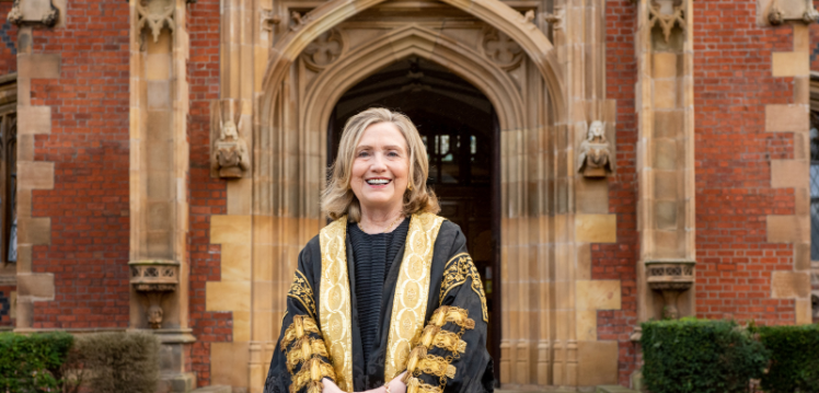 Queen's Chancellor, Secretary Clinton, photographed in front of the Lanyon's red brick on the morning of her installation as Chancellor
