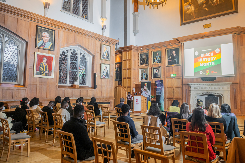 Students and staff listening to speech in QUB Great Hall for Black History Month 2021