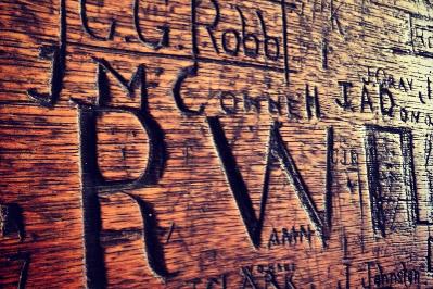 Names of past student residents of Riddel Hall carved into a wooden panel