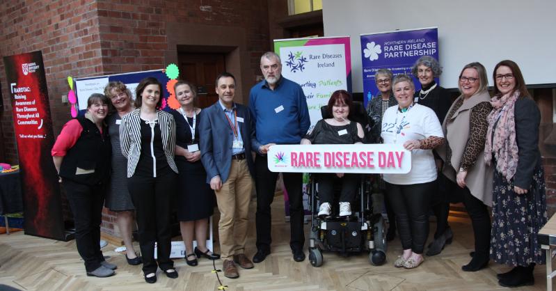 Group close up holding rare disease day banner