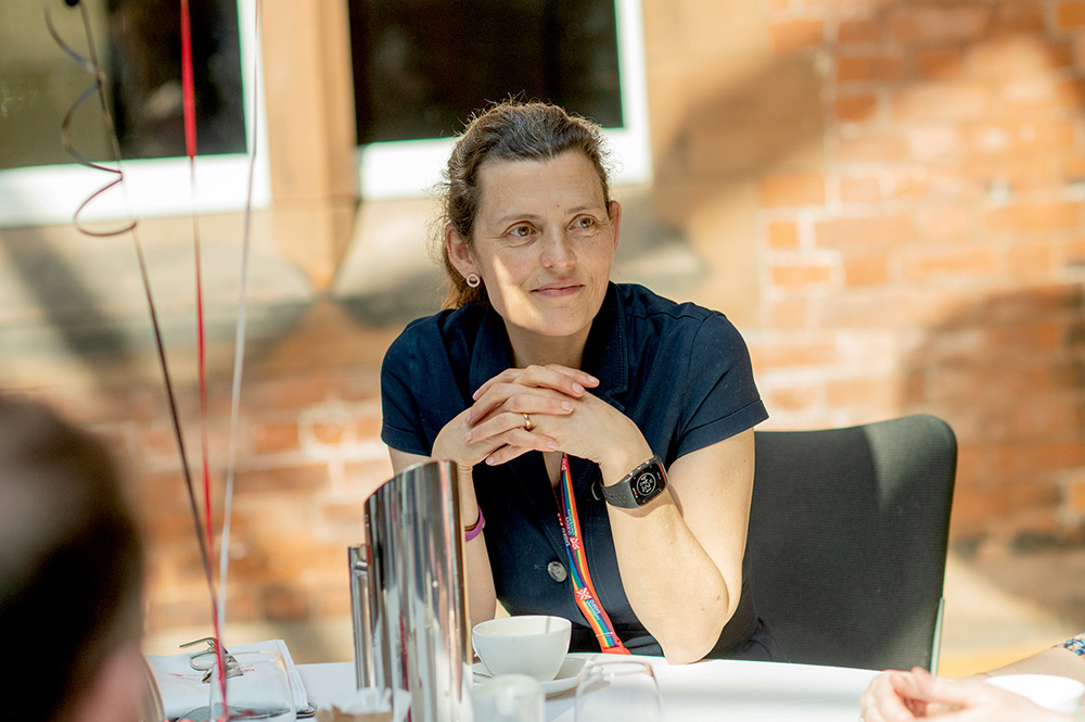 staff carer seated at a table at the Queen's Carers' Network lunch-launch