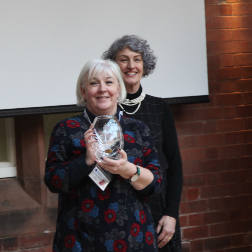 Fiona McLaughlin receiving crystal award